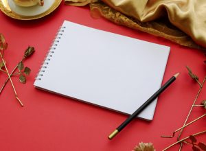 blank-note-book-on-royal-elegant-red-background_1644-68